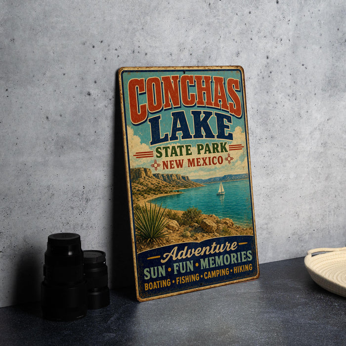A vintage-style metal sign advertising Conchas Lake, New Mexico, with a scenic image of the lake and surrounding landscape.