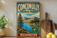 A vintage-style metal sign for Conconlly State Park in Washington, featuring a scenic landscape with mountains, a lake, and pine trees.