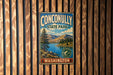 A vintage metal sign for Conconally State Park in Washington, featuring a scenic landscape with mountains, a lake, and pine trees.