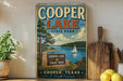 A vintage-style sign for Cooper Lake State Park in Texas, featuring a scenic illustration of the lake and surrounding landscape.
