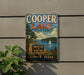 A vintage-style sign for Cooper Lake State Park, featuring a scenic illustration of the lake and surrounding landscape.