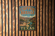 A vintage-style metal sign for Copper Breaks State Park in Texas, featuring a scenic landscape with a river and mountains.