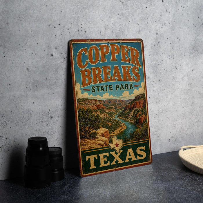 A vintage-style metal sign for Copper Breaks State Park in Texas, featuring a scenic landscape with a river and mountains.
