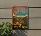 A vintage-style sign for Copper Breaks State Park in Texas, featuring a scenic landscape with a river and mountains.