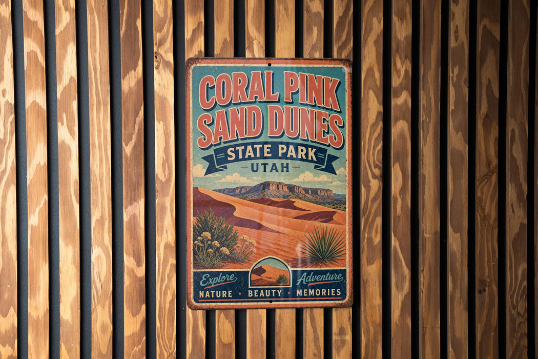 A vintage-style metal sign for the Coral Pink Sand Dunes State Park in Utah, featuring a desert landscape with mountains in the background.