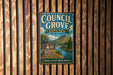 A metal sign for Council Grove State Park in Montana, featuring a scenic illustration of the park's natural surroundings.