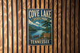 A vintage-style metal sign for Cove Lake State Park in Tennessee, featuring a scenic landscape with a lake, mountains, and a canoe.