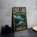 A vintage-style metal sign for Cove Lake State Park in Tennessee, featuring a scenic landscape with a lake, mountains, and a canoe.