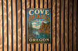 a vintage metal sign for Cove Palisades State Park in Oregon, mounted on a wooden wall.