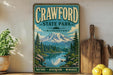 A vintage-style sign for Crawford State Park in Washington, featuring a scenic mountain landscape with pine trees and a lake.