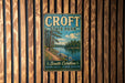 A vintage metal sign for Croft State Park, featuring a scenic landscape with a lake, trees, and a path leading to the park.