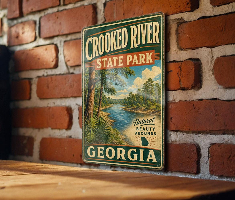 A vintage metal sign for Crooked River State Park in Georgia, featuring a scenic illustration of a river surrounded by trees and greenery.