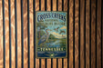 A vintage-style metal sign for the Cross Creek National Wildlife Refuge in Tennessee, featuring an illustration of a bird and a pond.