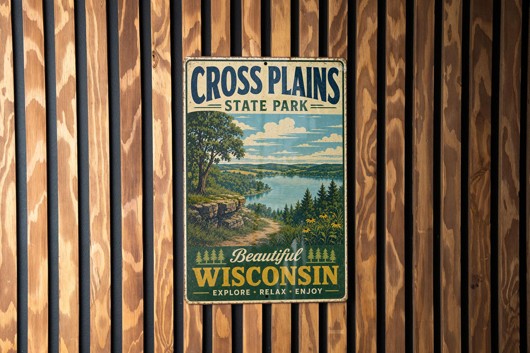 A vintage metal sign for Cross Plains State Park in Wisconsin, featuring a scenic landscape with a lake and mountains.