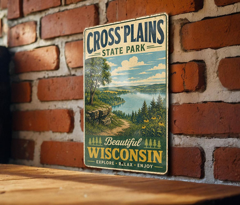 A vintage metal sign for Cross Plains State Park in Wisconsin, featuring a scenic landscape with a lake and forest.