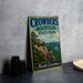 A vintage metal sign for Crowders Mountain State Park in North Carolina, featuring a scenic mountain landscape with a river and pine trees.
