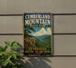 A vintage metal sign for Cumberland Mountain State Park, featuring a scenic mountain landscape with a river and pine trees.