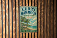 A vintage metal sign for "Curry Hammock State Park, Florida" is displayed on a wooden wall.