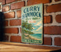 A vintage-style metal sign for "Curry Hammock State Park, Florida" is displayed on a brick wall.