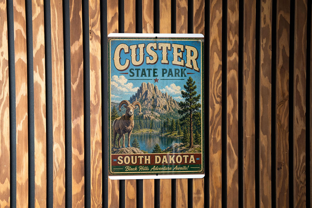 A vintage-style metal sign for Custer State Park in South Dakota, featuring a mountain landscape and a goat.