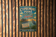 A vintage-style metal sign for Cypremort Point State Park in Louisiana, featuring a blue background with a white bird and text promoting the park's coastal beauty, natural habitat, and outdoor adventures.