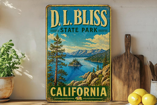 A vintage-style metal sign for D.L. Bliss State Park in California, featuring a scenic landscape with mountains, a lake, and pine trees.