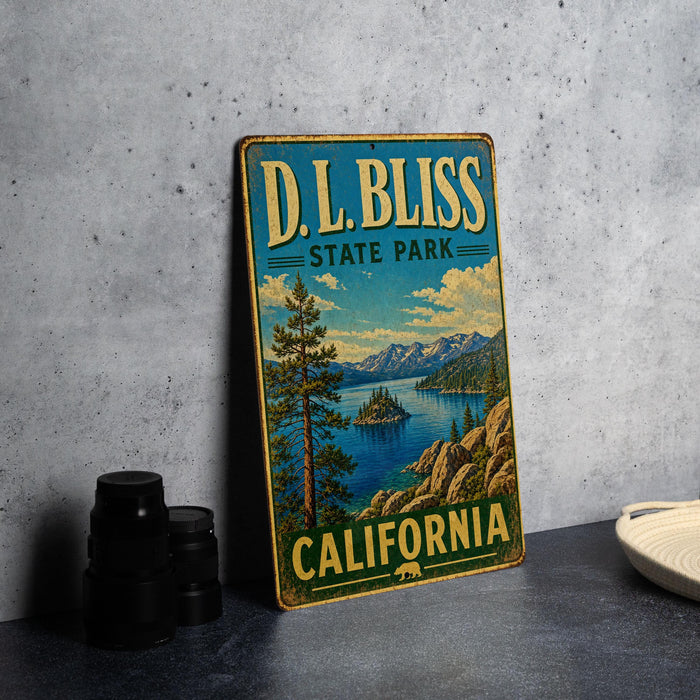 A vintage-style metal sign for D.L. Bliss State Park in California, featuring a scenic landscape with mountains, a lake, and pine trees.