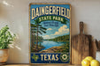 A vintage-style sign for Dainingfield State Park in Texas, featuring a scenic landscape with a lake and pine trees.
