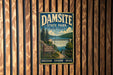 A vintage metal sign for Damsite State Park in New York, featuring a scenic landscape with a waterfall and a sign that says "Discover, Explore, Relax".