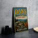 A vintage metal sign for Dan's Mountain State Park in Maryland, featuring a scenic mountain landscape with autumn foliage.