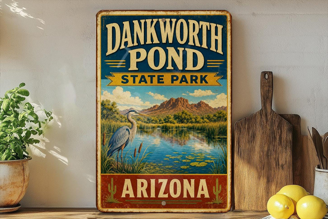 A vintage-style sign for Dankworth Pond State Park in Arizona, featuring a scenic landscape with a heron and a pond surrounded by mountains.