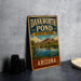 A vintage-style sign for Dankworth Pond State Park in Arizona, featuring a scenic illustration of the pond and surrounding landscape.