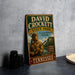 A vintage-style metal sign for David Crockett State Park in Tennessee, featuring a man in hunting gear and the park's name.