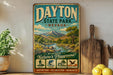 A vintage-style metal sign for Dayton State Park, Nevada, featuring a scenic mountain landscape and various outdoor activities such as hiking, fishing, picnicking, and wildlife watching.