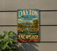 A vintage metal sign for Dayton State Park, Nevada, featuring a scenic landscape with mountains, a river, and various outdoor activities such as hiking, fishing, and wildlife viewing.