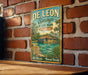 A vintage-style metal sign for De Leon Springs State Park in Florida, featuring a tropical landscape with palm trees and a house on a lake.