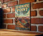 A vintage metal sign for Dead Horse Point, a famous landmark in Utah, is displayed on a brick wall.