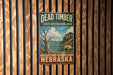 A vintage metal sign for Dead Timber State Recreation Area in Nebraska, featuring a scenic landscape with a lake and mountains.