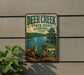 A vintage metal sign for Deer Creek State Park in Ohio, featuring a deer and a scenic landscape.