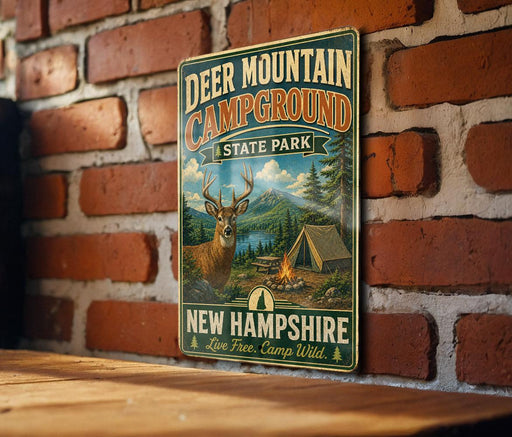 A vintage-style metal sign for Deer Mountain Campground in New Hampshire, featuring a deer and camping equipment.