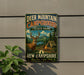 A metal sign for Deer Mountain Campground in New Hampshire, featuring a deer and camping equipment.