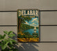A vintage metal sign for Delabar State Park, featuring a scenic landscape with a lake, sailboat, and lush greenery.