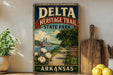 A vintage-style sign for Delta Heritage Trail State Park in Arkansas, featuring a scenic illustration of a river, cotton field, and a steamboat.