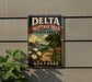 A vintage-style metal sign for Delta Heritage Trail State Park in Arkansas, featuring a scenic illustration of a river, cotton fields, and a steamboat.