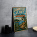 A vintage-style sign for Demarest Lloyd State Park in Massachusetts, featuring a scenic landscape with a lake, mountains, and pine trees.