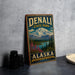 A vintage-style metal sign for Denali State Park in Alaska, featuring a mountain landscape and text promoting the park's adventure, discovery, and wilderness.