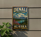 A vintage metal sign for Denali State Park in Alaska, featuring a scenic mountain landscape with a lake and pine trees.