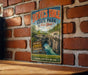 A vintage-style metal sign for Devil's Hole State Park in New York, featuring a scenic image of the park's natural landscape.