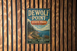A vintage-style metal sign for DEWOLF POINT STATE PARK, NEW YORK, featuring a scenic landscape with a path leading to a body of water.