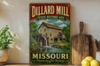 A vintage-style sign for the Dillard Mill State Historic Site in Missouri, featuring a wooden mill building and a waterfall.
